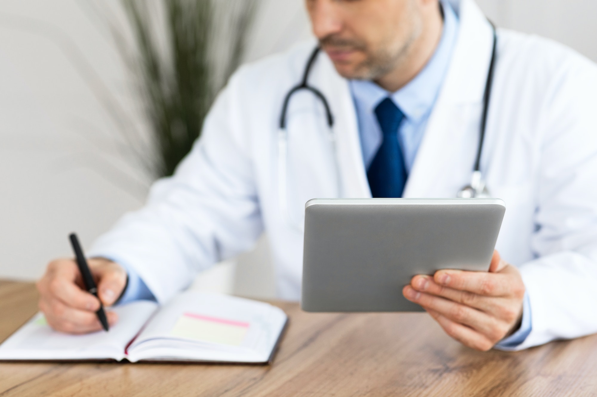 Close up of medical practitioner filling in paperwork